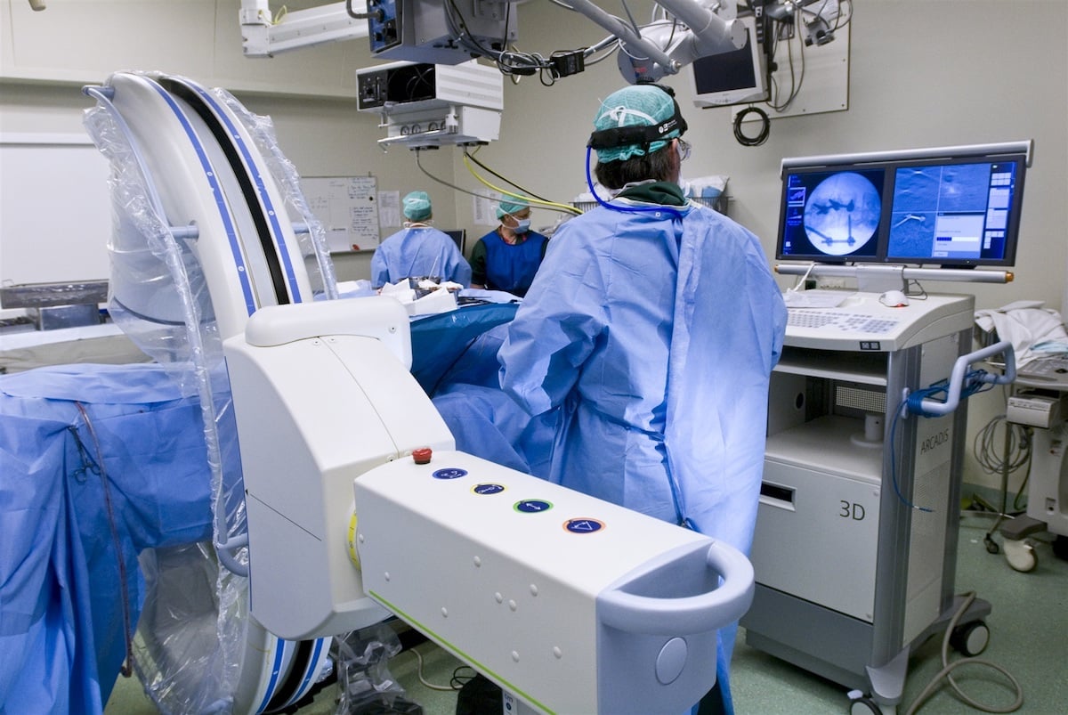 Artsen zijn in een moderne operatiekamer bezig met een operatie.